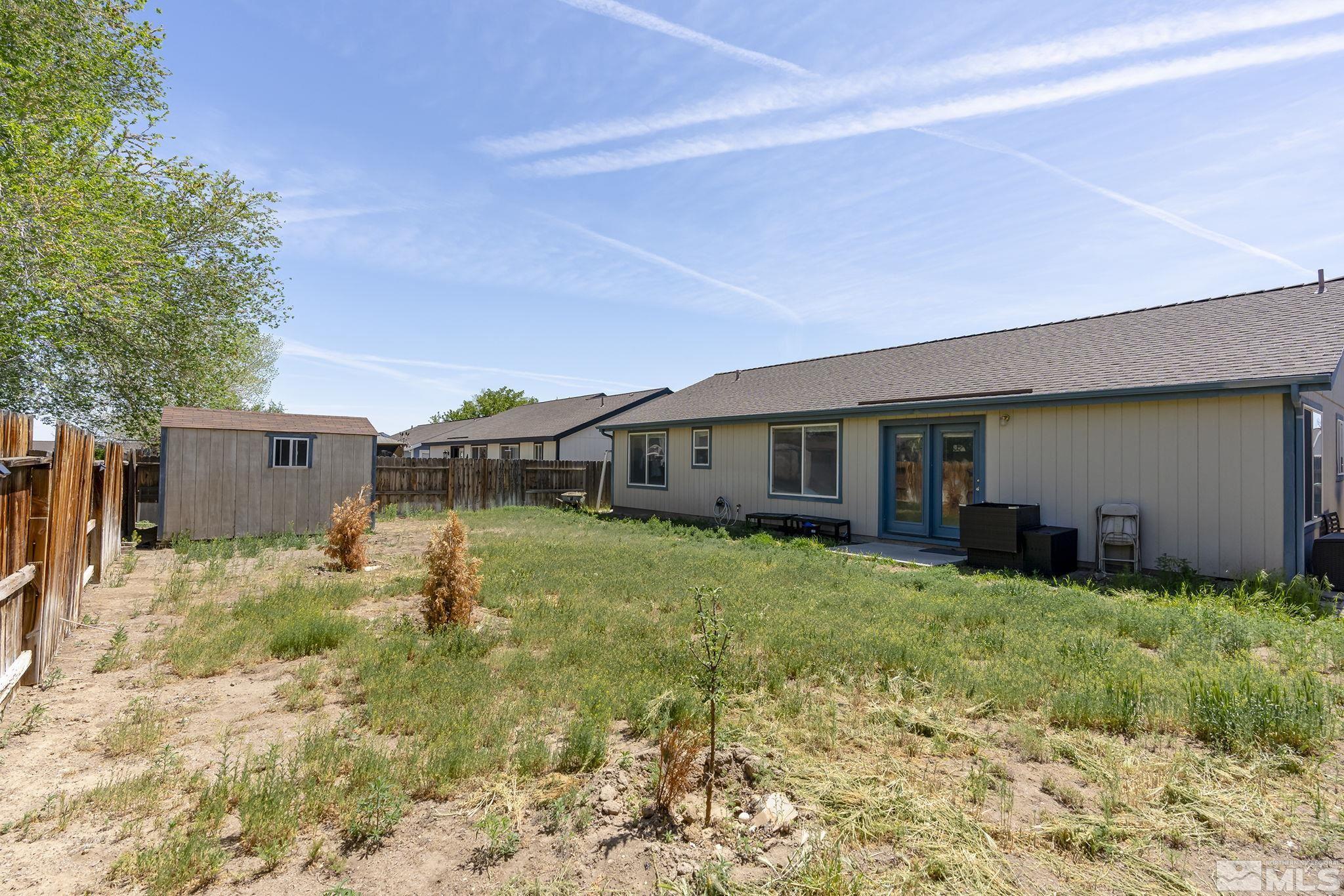 940 Atrium Road Fernley, NV 89408 - Photo 19 of 20 a backyard of a house with yard and outdoor seating