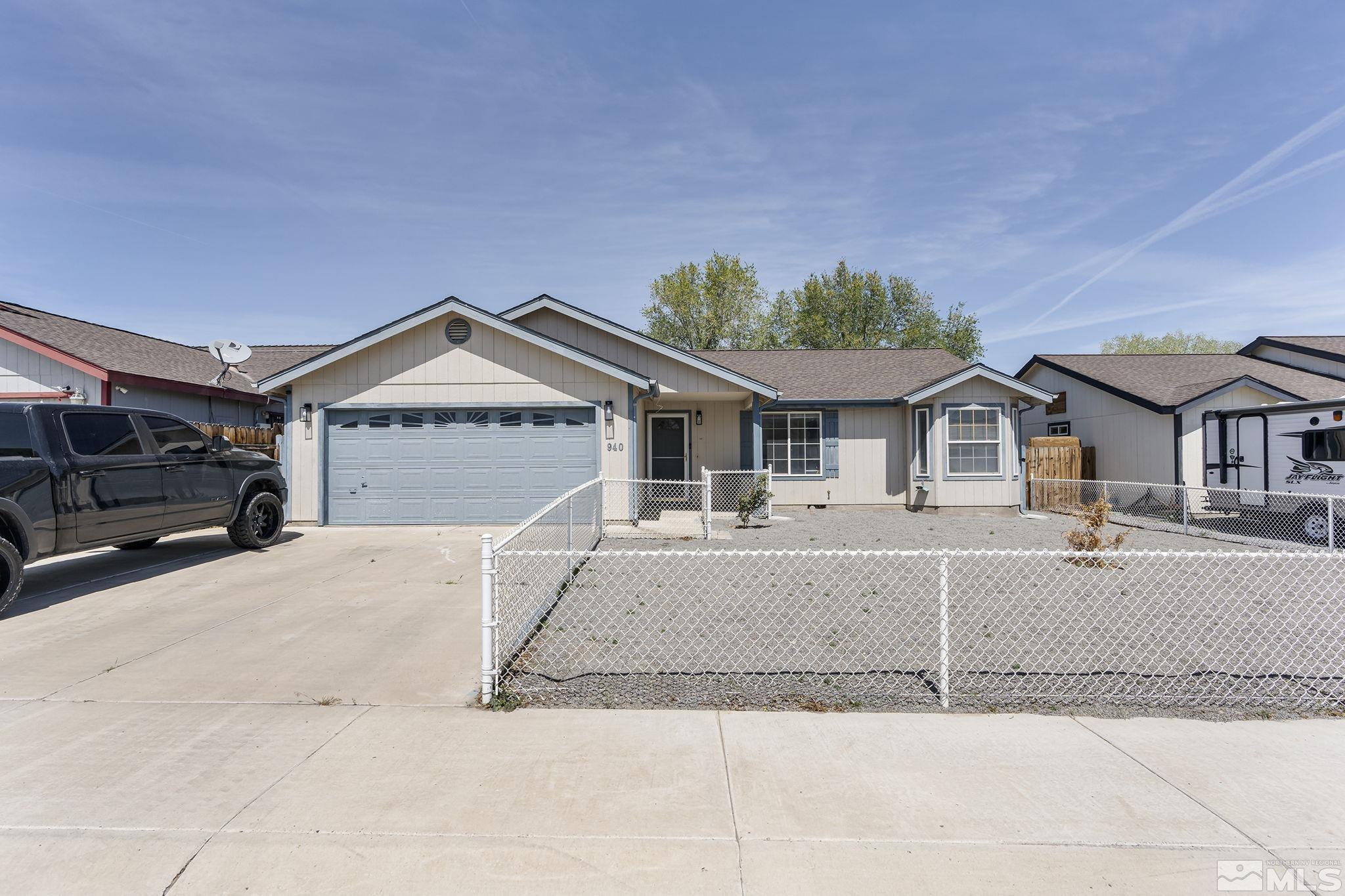 940 Atrium Road Fernley, NV 89408 - Photo 20 of 20 a front view of a house with a yard and garage
