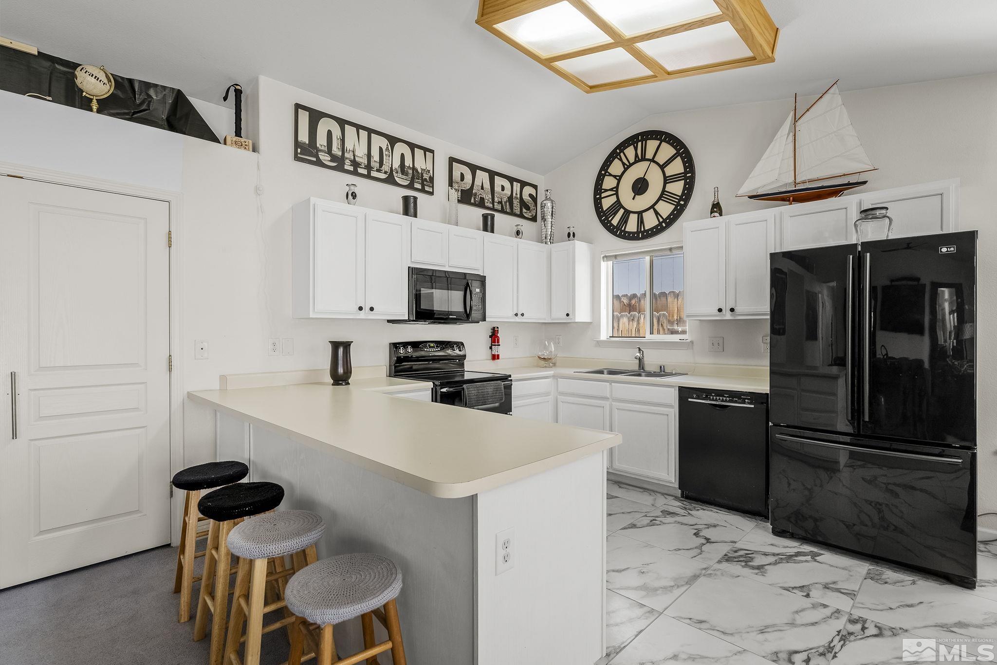 940 Atrium Road Fernley, NV 89408 - Photo 8 of 20 a kitchen with a refrigerator a stove top oven a sink and dishwasher