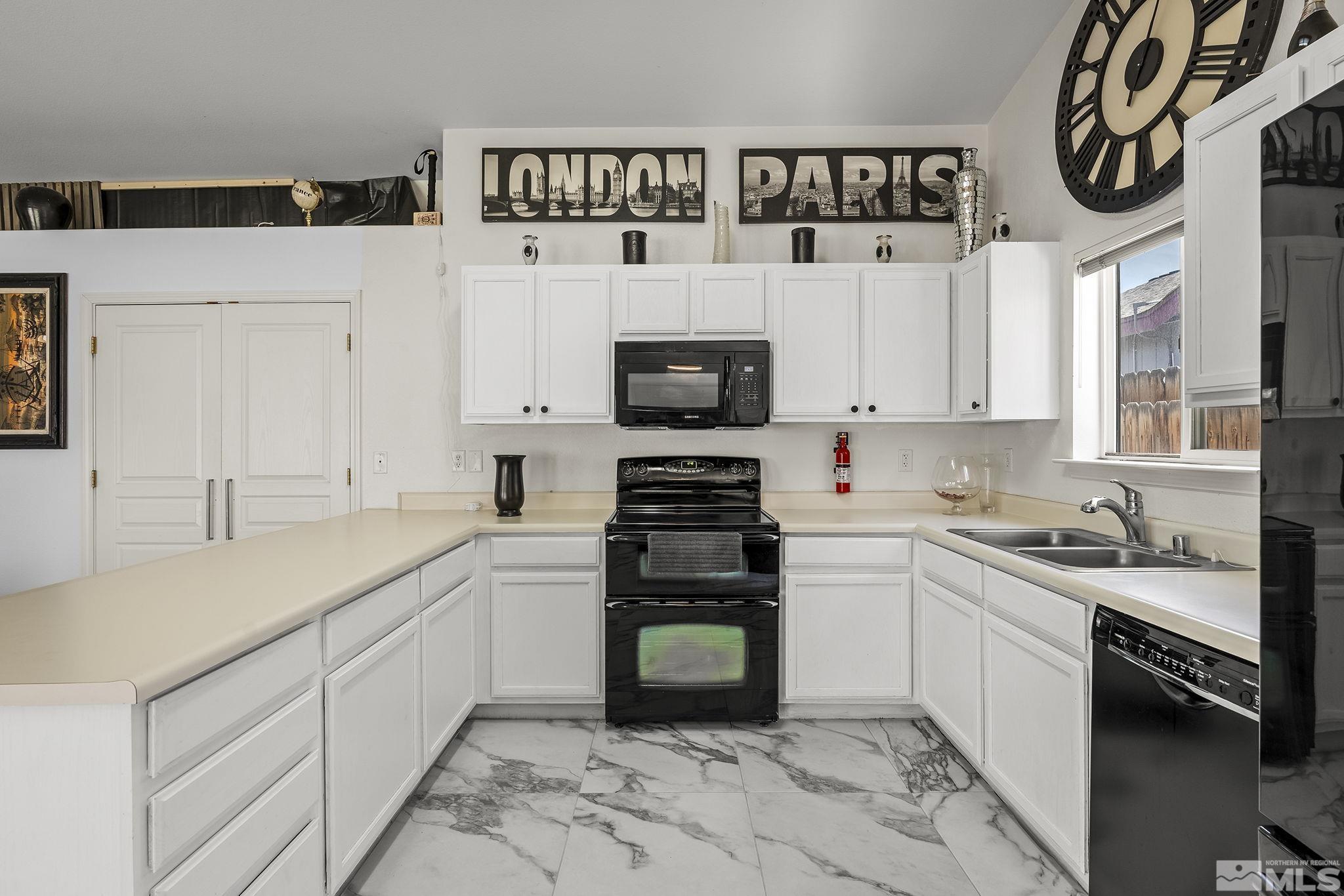 940 Atrium Road Fernley, NV 89408 - Photo 9 of 20 a kitchen with granite countertop a sink and a stove