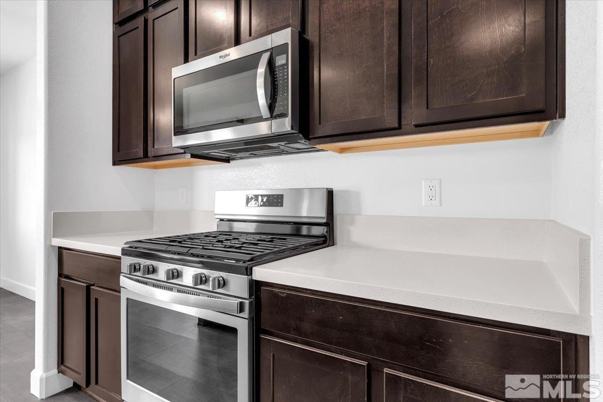 9885 Ash Meadow Drive Reno, NV 89521 - Photo 10 of 40 a kitchen with a stove and a microwave