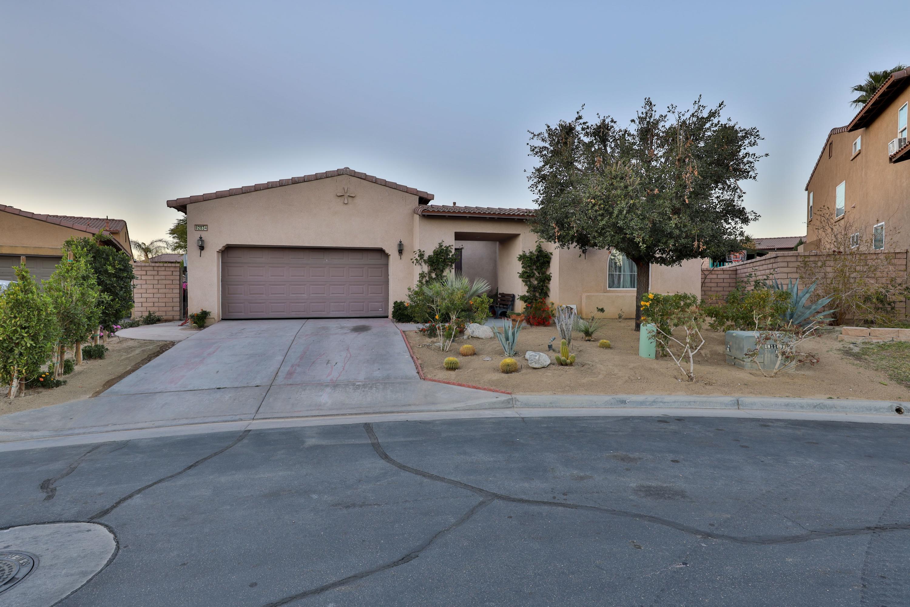 82834 Randsburg Lane Indio, CA 92203 - Photo 1 of 18 a front view of a house with a yard and garage