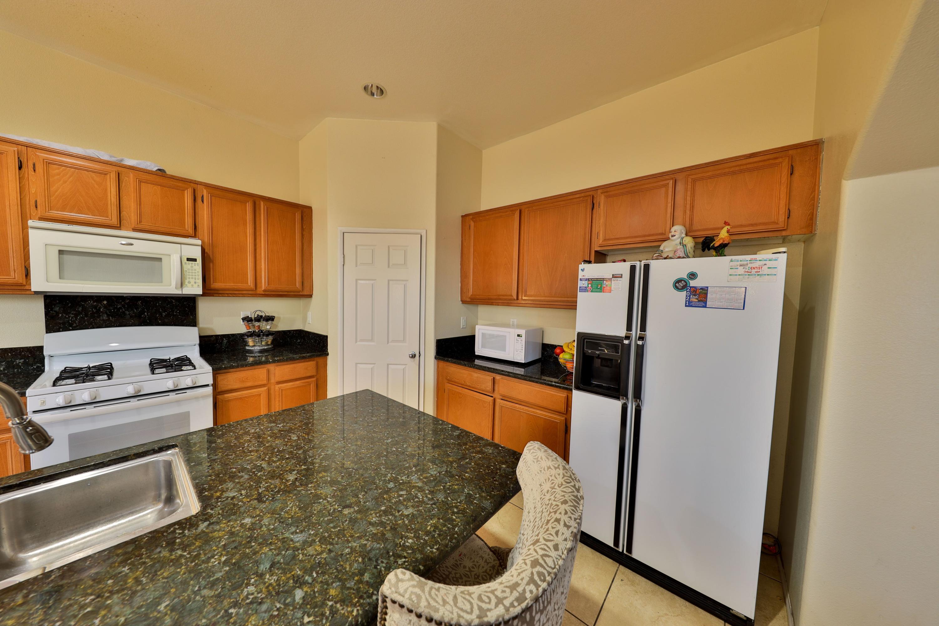 82834 Randsburg Lane Indio, CA 92203 - Photo 2 of 18 a kitchen with stainless steel appliances granite countertop a refrigerator a stove top oven a sink and dishwasher