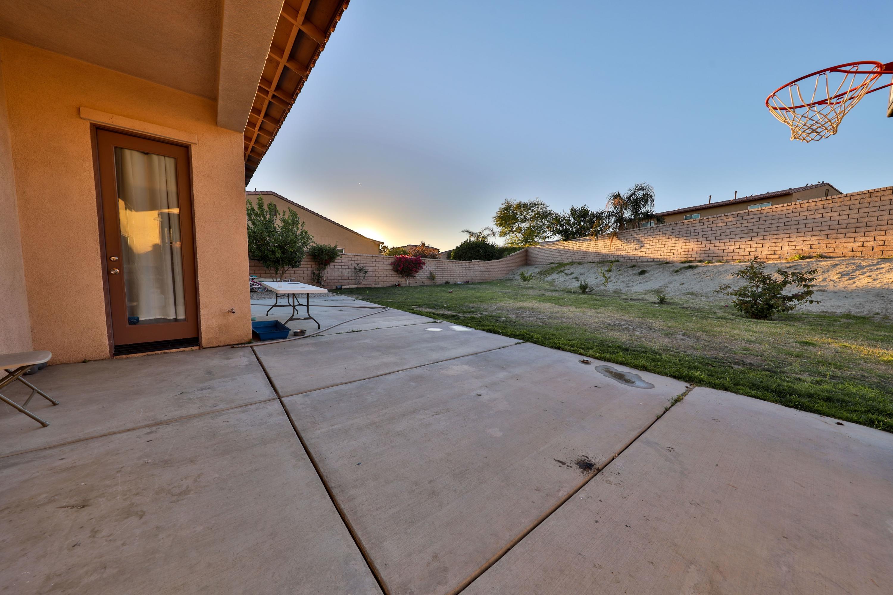 82834 Randsburg Lane Indio, CA 92203 - Photo 14 of 18 a view of a house with a yard and potted plants