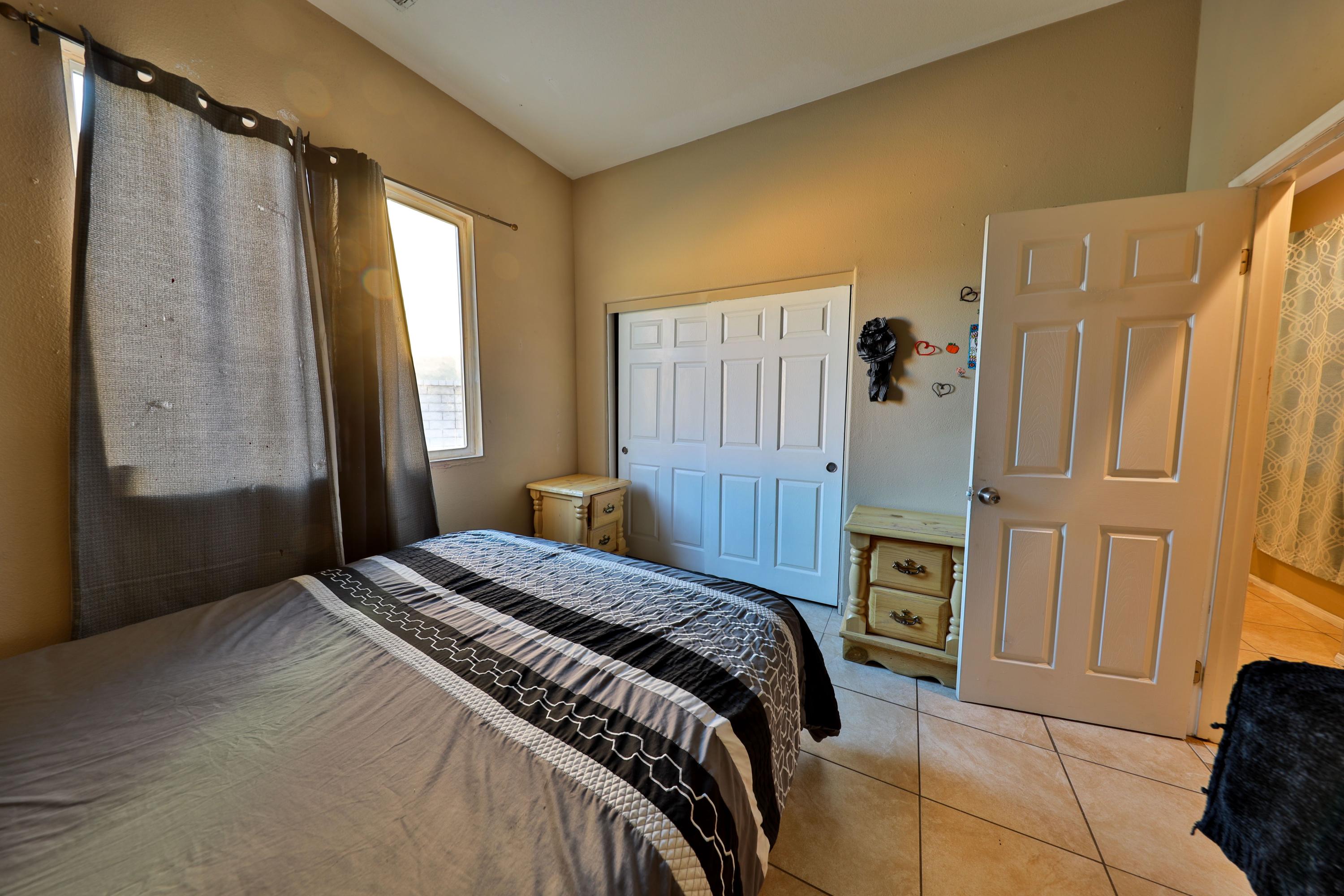82834 Randsburg Lane Indio, CA 92203 - Photo 15 of 18 a bedroom with a bed and a mirror