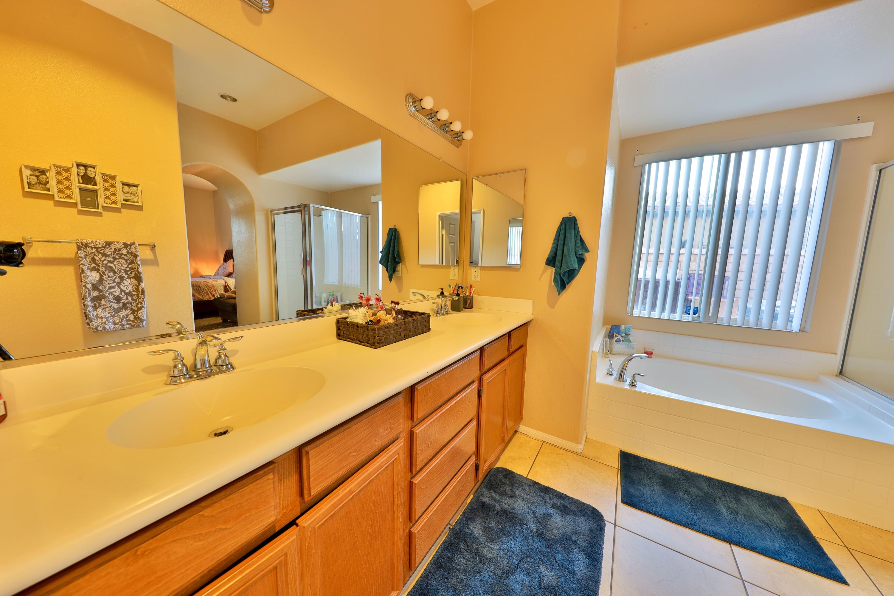 82834 Randsburg Lane Indio, CA 92203 - Photo 16 of 18 a bathroom with a tub sink and mirror