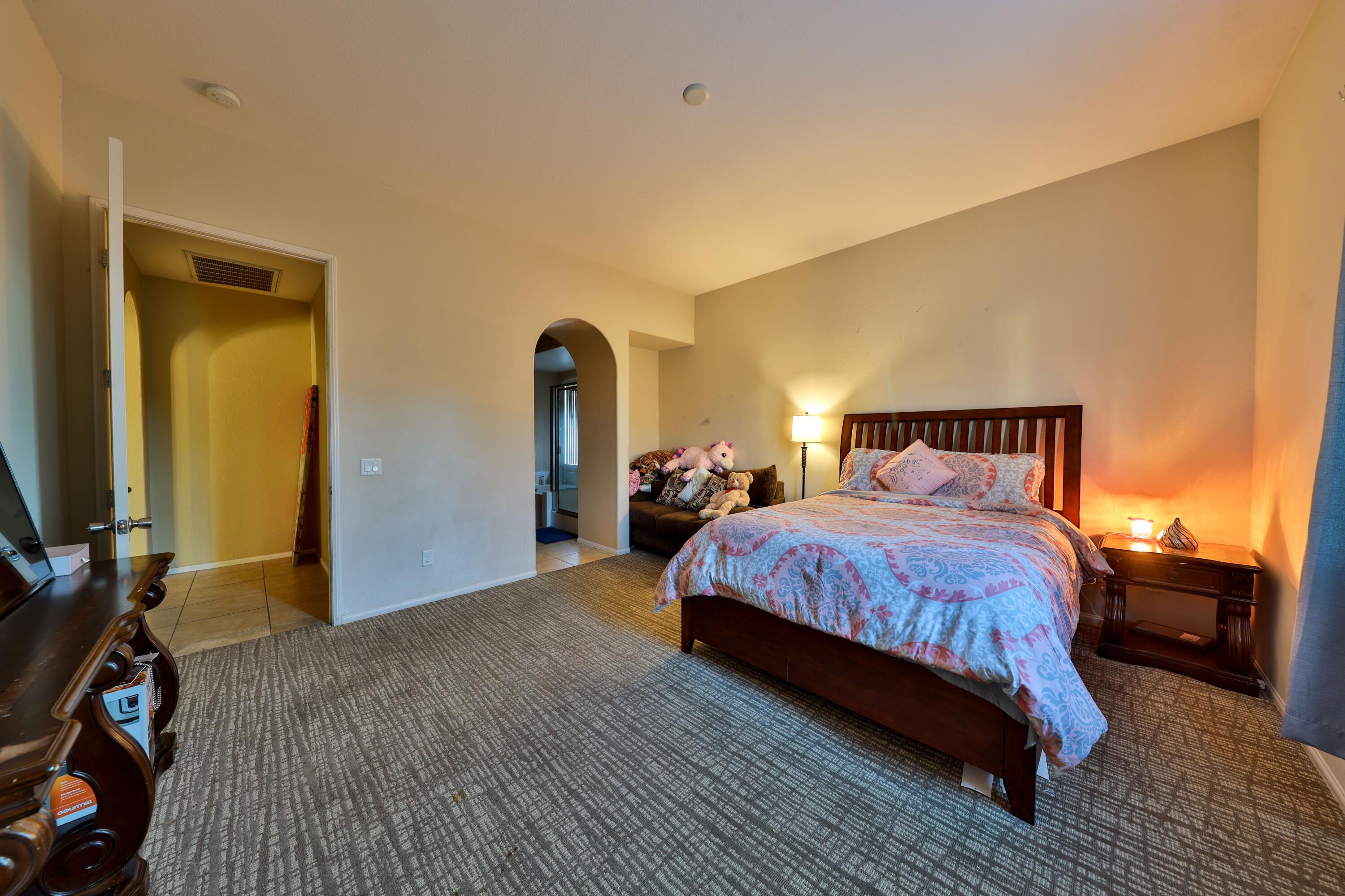 82834 Randsburg Lane Indio, CA 92203 - Photo 18 of 18 a bedroom with a bed and a flat tv screen on dresser