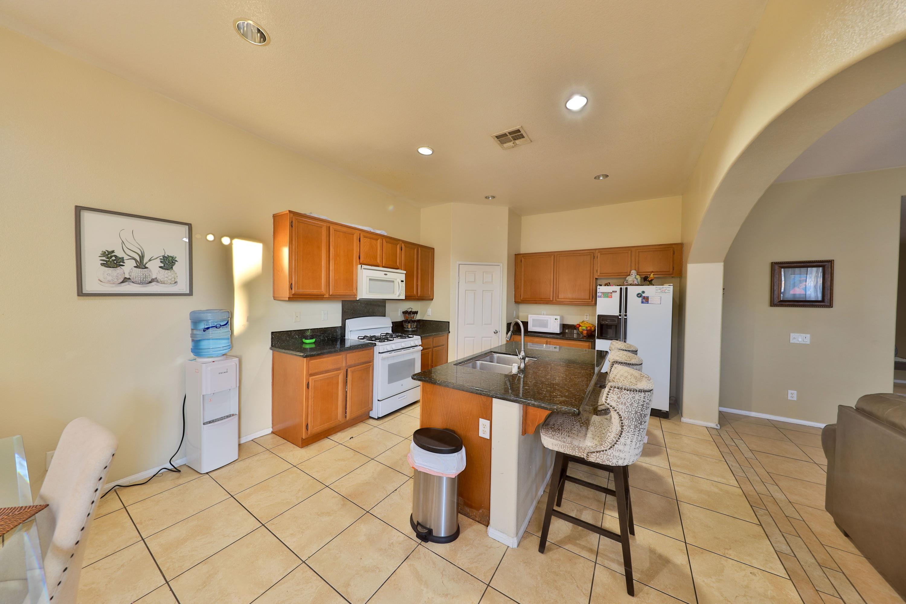82834 Randsburg Lane Indio, CA 92203 - Photo 4 of 18 a living room with furniture and a flat screen tv