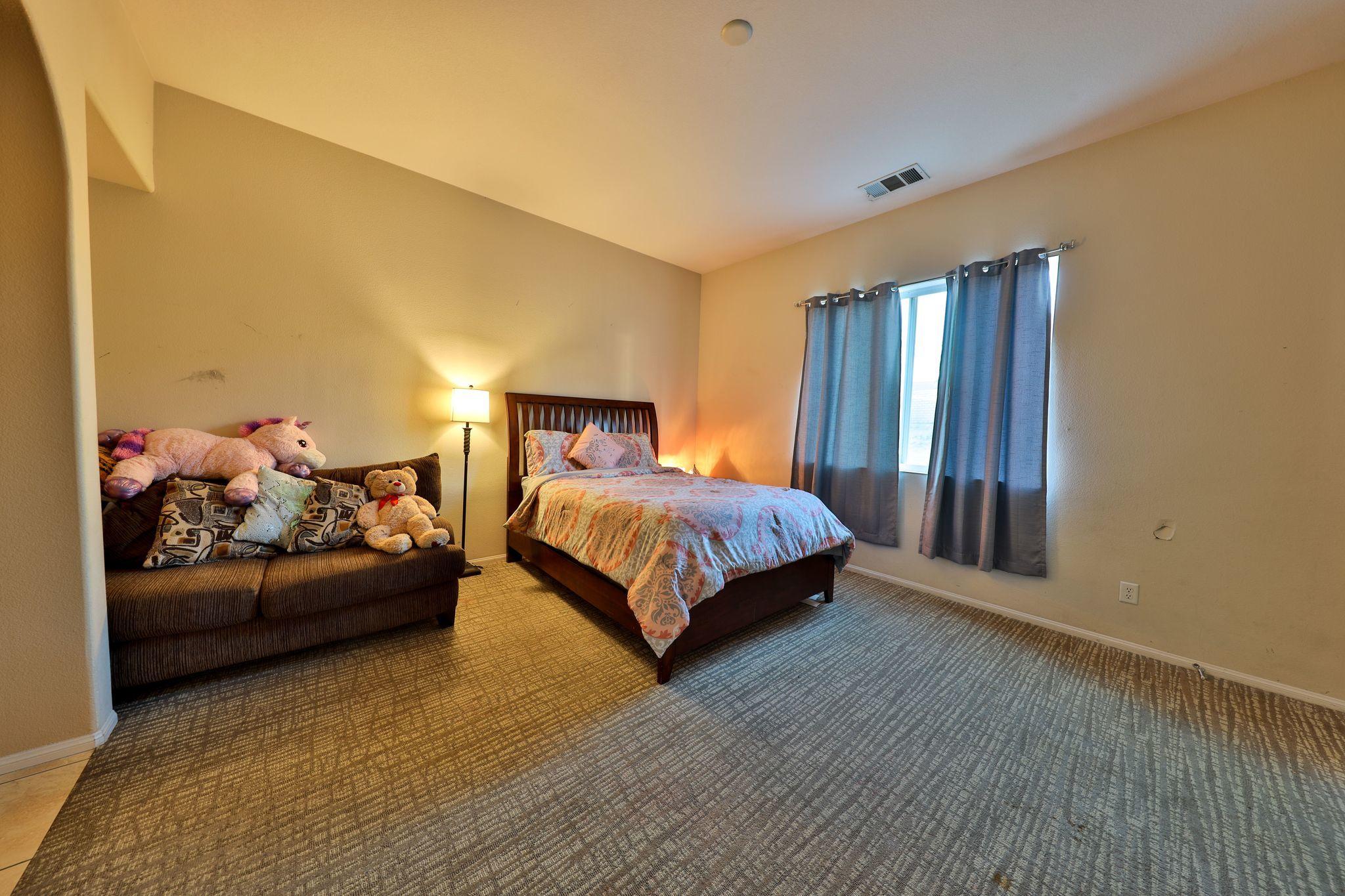82834 Randsburg Lane Indio, CA 92203 - Photo 8 of 18 a bedroom with a bed and window