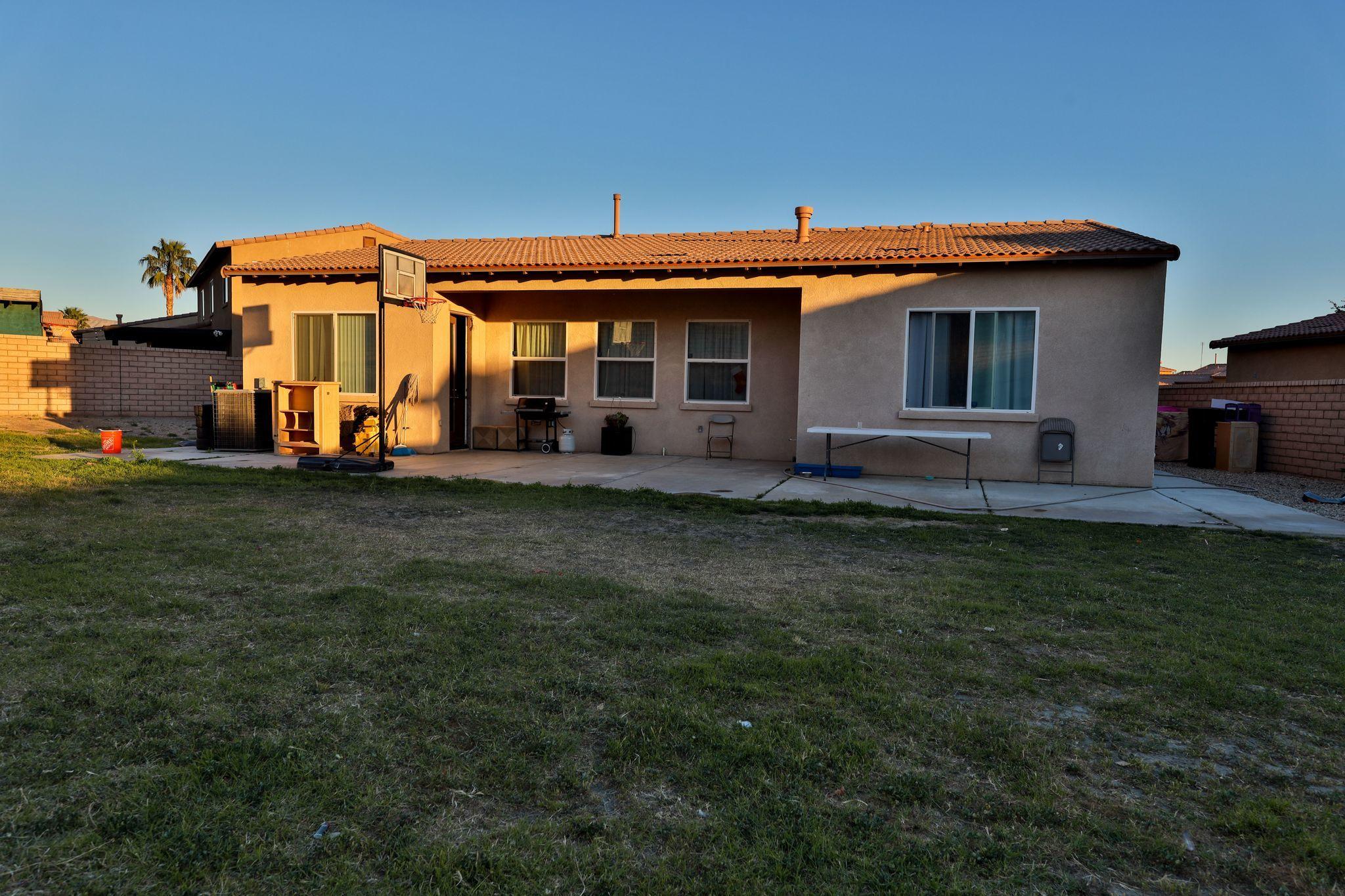 82834 Randsburg Lane Indio, CA 92203 - Photo 10 of 18 a view of a house with a backyard