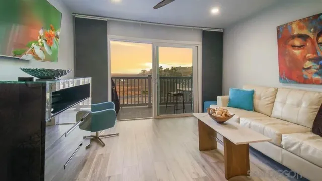 a living room with furniture and a floor to ceiling window