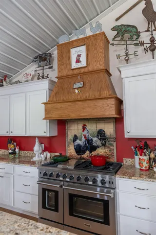 a kitchen with stainless steel appliances granite countertop a stove and cabinets