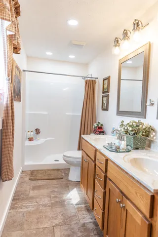 a front view of house with yard and trees in the background