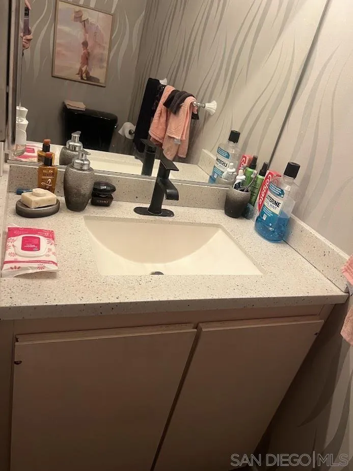 2630 Torrey Pines Road, Unit E21 La Jolla, CA 92037 - Photo 13 of 24 a bathroom with a sink and a mirror