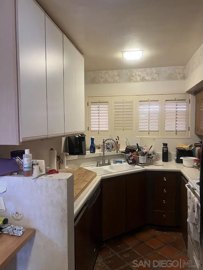 2630 Torrey Pines Road, Unit E21 La Jolla, CA 92037 - Photo 3 of 24 a kitchen with a sink a stove and cabinets