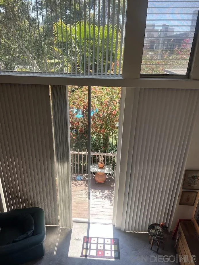 2630 Torrey Pines Road, Unit E21 La Jolla, CA 92037 - Photo 8 of 24 a view of a balcony with chair and floor to ceiling window