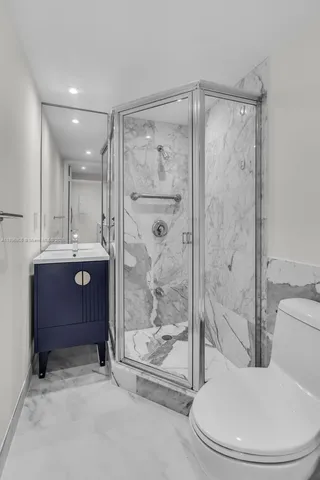 a bathroom with a shower a toilet and sink