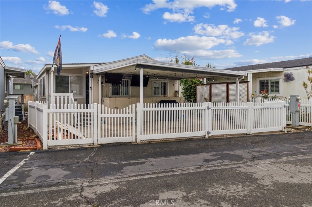 8221 Ilex Street, Unit 10 Rancho Cucamonga, CA 92335 - Photo 2 of 27 a front view of a house with a porch