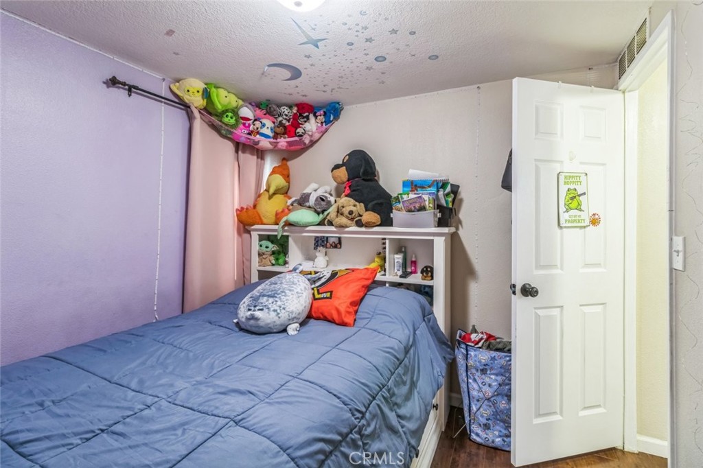 8221 Ilex Street, Unit 10 Rancho Cucamonga, CA 92335 - Photo 21 of 27 a bedroom with a bed and a window