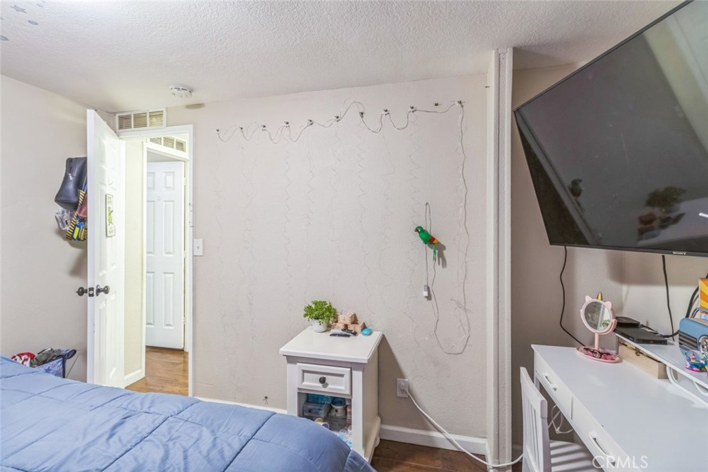 8221 Ilex Street, Unit 10 Rancho Cucamonga, CA 92335 - Photo 22 of 27 a bedroom with a bed and a workspace
