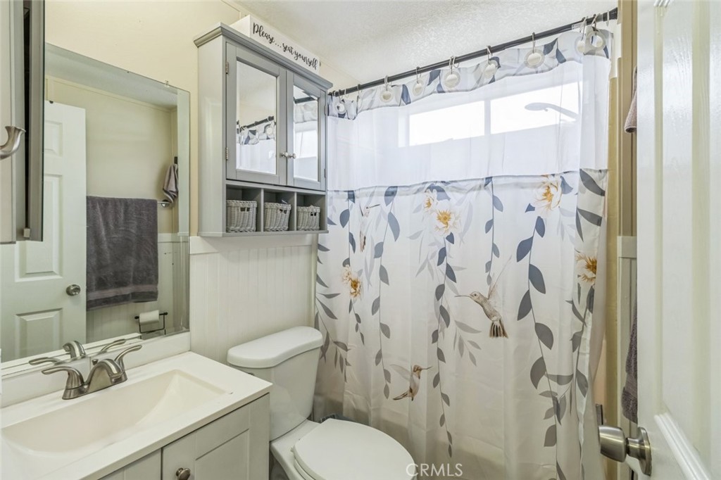 8221 Ilex Street, Unit 10 Rancho Cucamonga, CA 92335 - Photo 24 of 27 a bathroom with a sink and a mirror