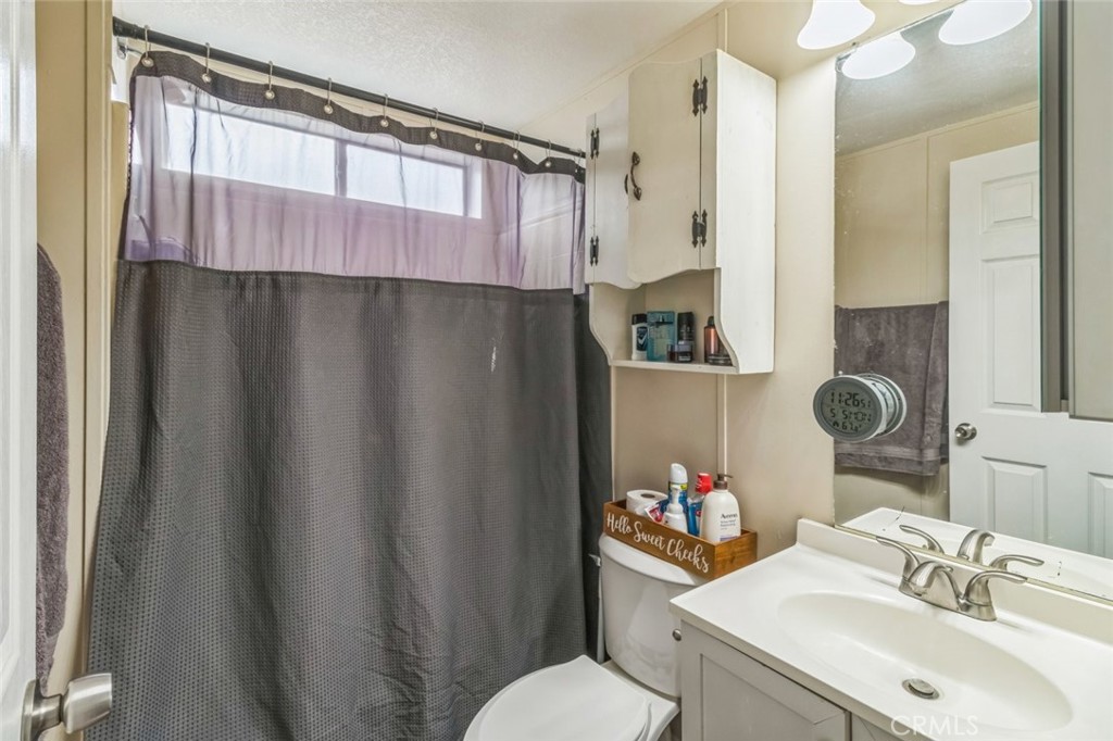 8221 Ilex Street, Unit 10 Rancho Cucamonga, CA 92335 - Photo 25 of 27 a bathroom with a sink toilet and shower