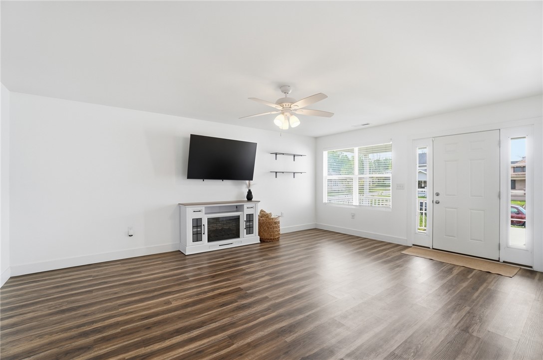 728 East Northern Avenue Springfield, OH 45503 - Photo 6 of 35 This bright living space features wood flooring and large windows, creating an inviting atmosphere.