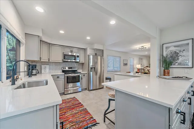 a large kitchen with kitchen island a sink appliances a counter space and a center island