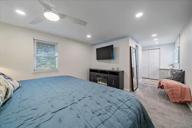 a bedroom with a bed and a flat screen tv