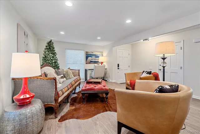 a living room with furniture and a lamp