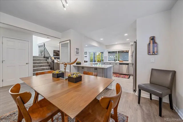 a dining room with furniture and wooden floor
