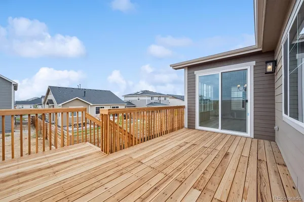 a view of a wooden deck with a yard