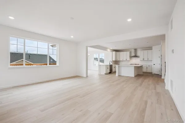 a view of kitchen and wooden floor