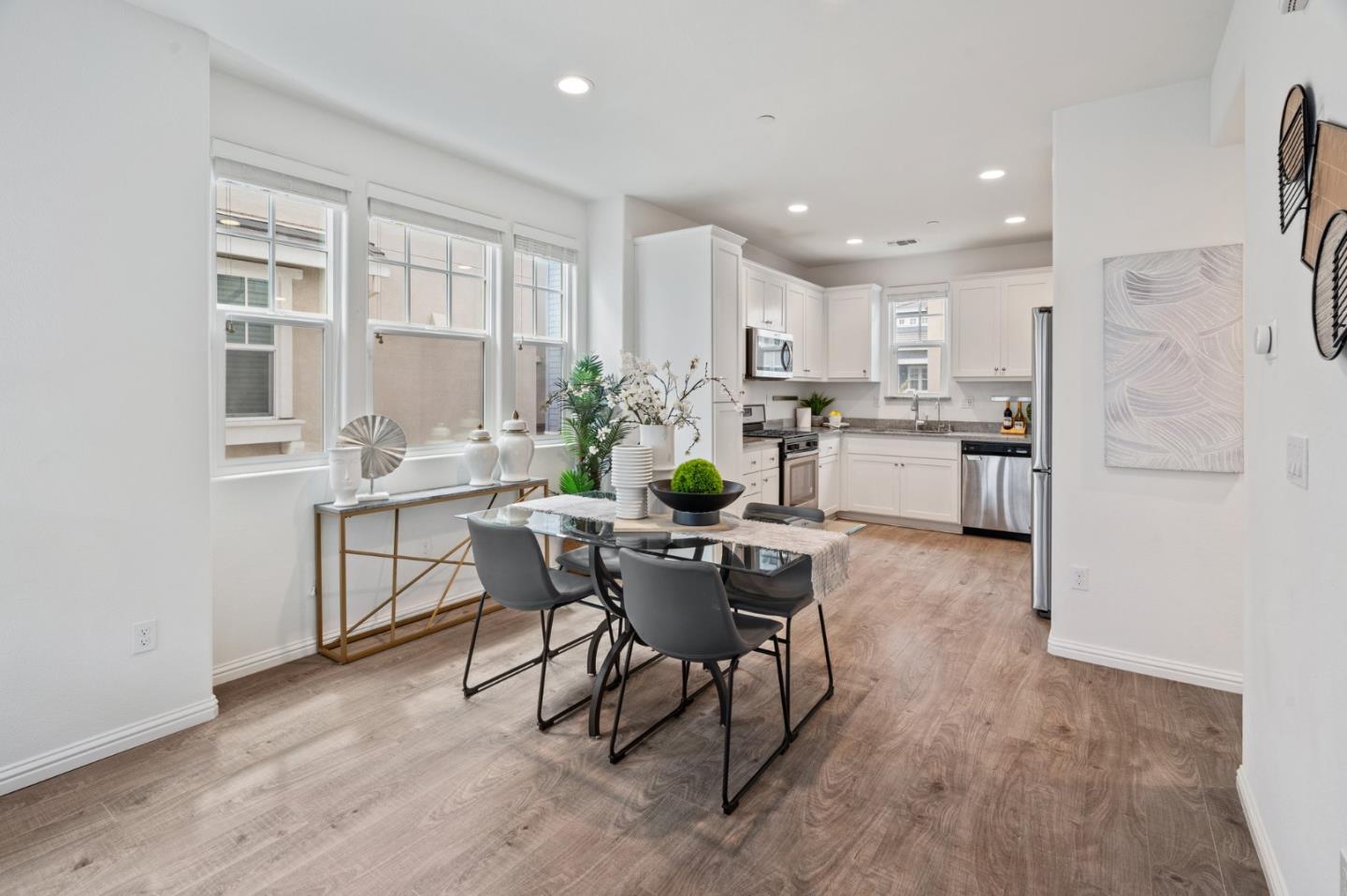 3410 Pyramid Way Mountain View, CA 94043 - Photo 11 of 55 a dining room with stainless steel appliances kitchen island granite countertop a dining table chairs and view living room