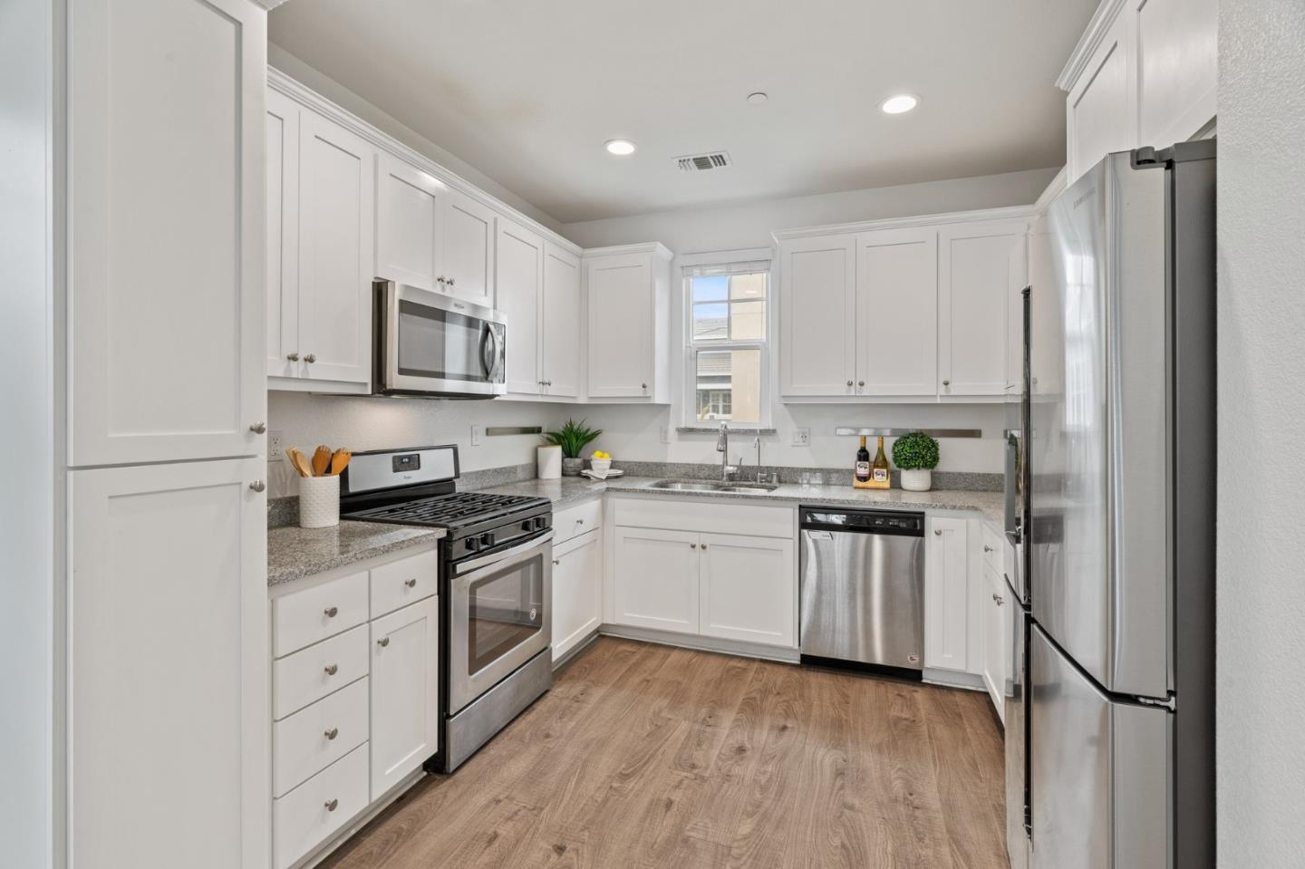 3410 Pyramid Way Mountain View, CA 94043 - Photo 14 of 55 a kitchen with white cabinets and stainless steel appliances