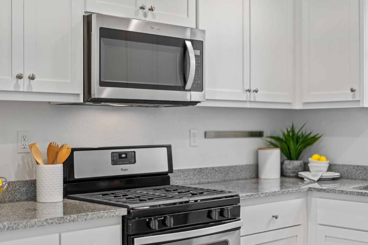 3410 Pyramid Way Mountain View, CA 94043 - Photo 16 of 55 a kitchen with stainless steel appliances granite countertop a stove a white cabinet and a granite countertops with wooden floor
