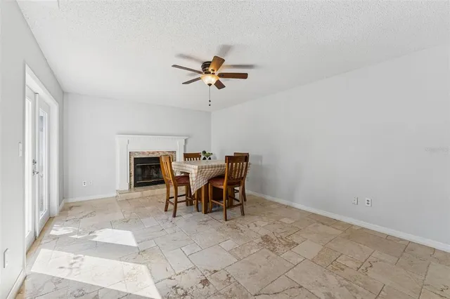 a view of a livingroom with furniture and a ceiling fan