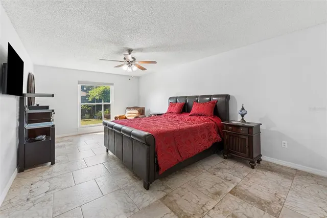 a bed room with a bed and a television