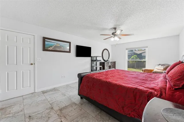 a bedroom with a large bed and a chandelier