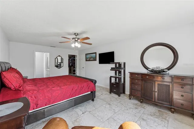 a living room with furniture a mirror and a flat screen tv