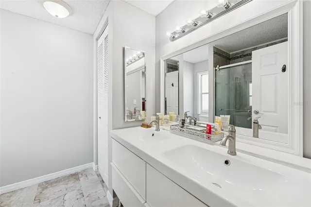 a bathroom with double vanity sink and a mirror