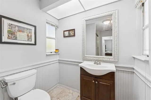 a bathroom with a toilet sink and mirror