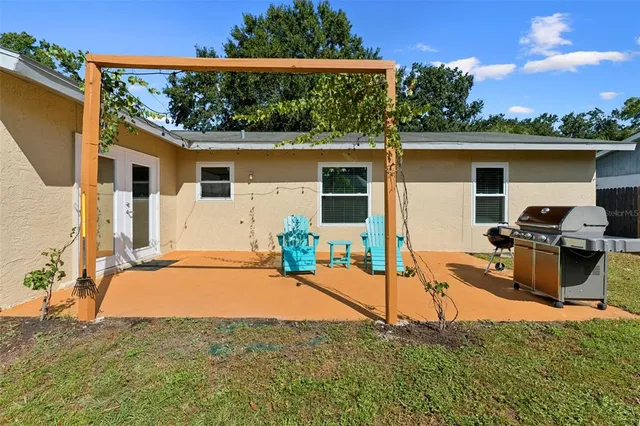 a backyard of a house with table and chairs