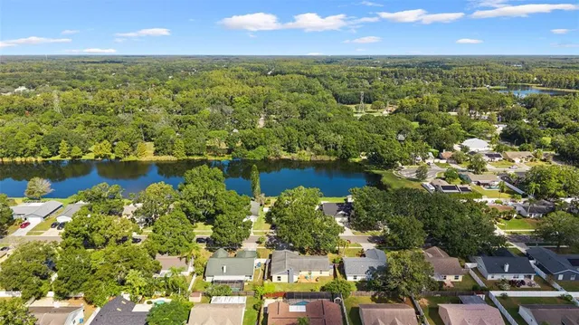 an aerial view of residential houses with outdoor space and lake view