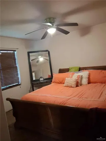 a bedroom with a bed and a mirror