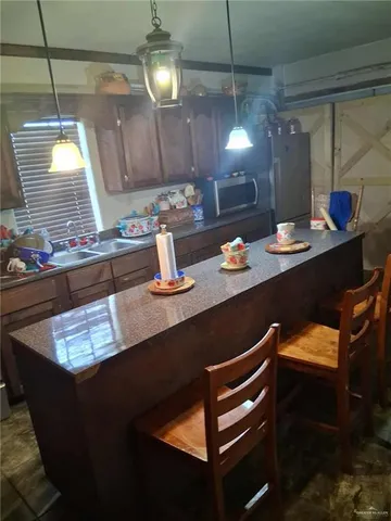 a kitchen with a sink appliances and cabinets