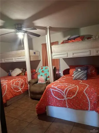 a bedroom with two beds and a potted plant