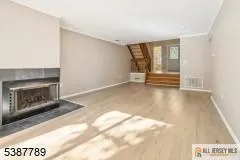 a view of an empty room with glass door and windows