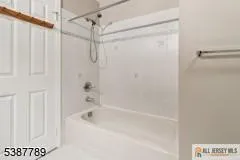 a bathroom with a shower and a bath tub