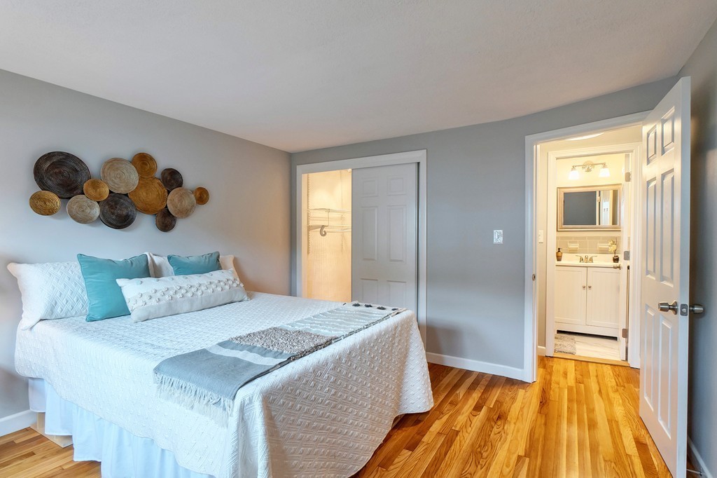 84 Renwick Road, Unit C Wakefield, MA 01880 - Photo 19 of 29 a bedroom with a bed and wooden floor